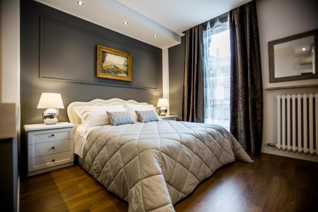ein Schlafzimmer mit einem großen Bett und einem Fenster in der Unterkunft Arena Suite in Verona