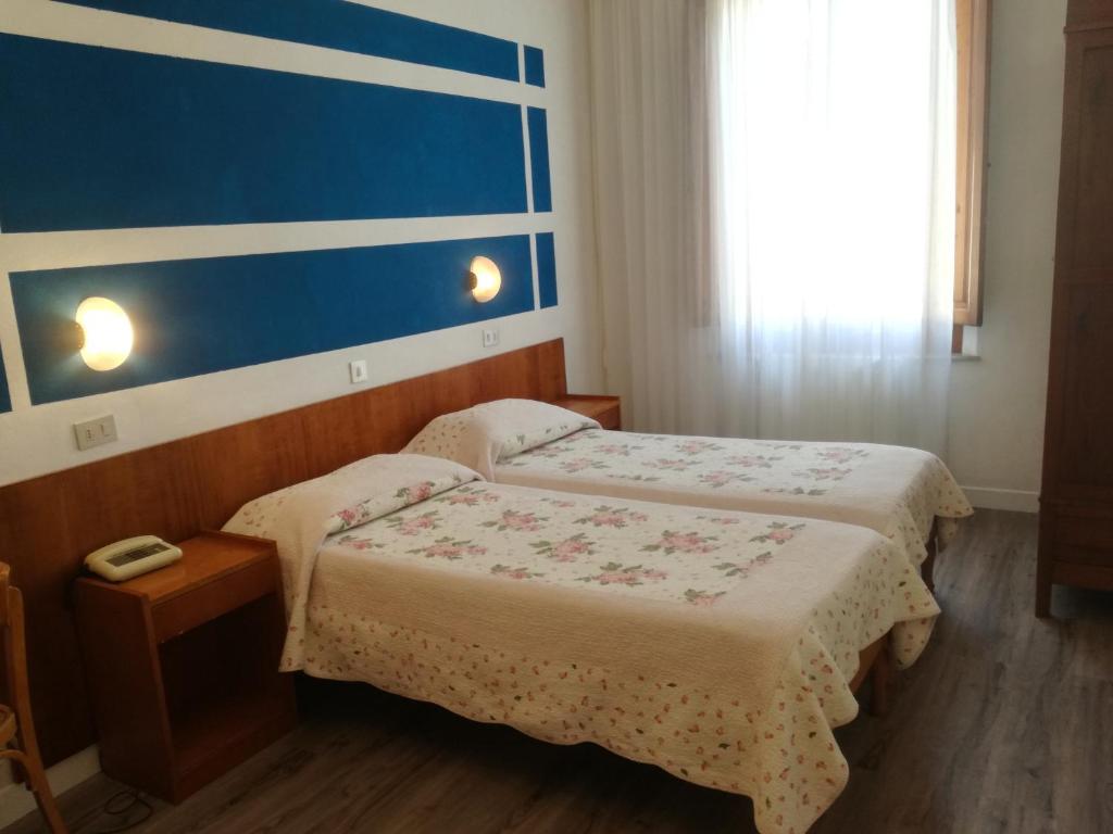 Postel nebo postele na pokoji v ubytování Hotel Prati