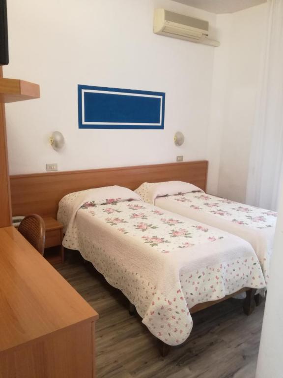 Postel nebo postele na pokoji v ubytování Hotel Prati