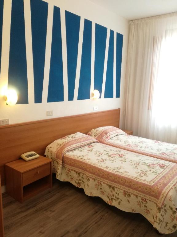 Postel nebo postele na pokoji v ubytování Hotel Prati