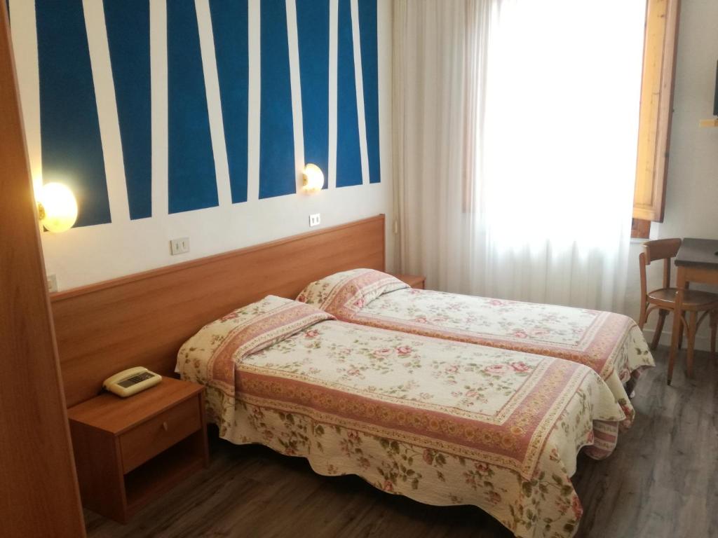 Postel nebo postele na pokoji v ubytování Hotel Prati