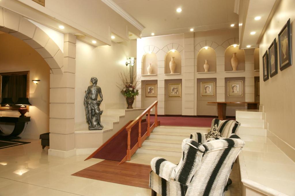 a lobby with a statue in the center of a building at Apollo Hotel in Johannesburg