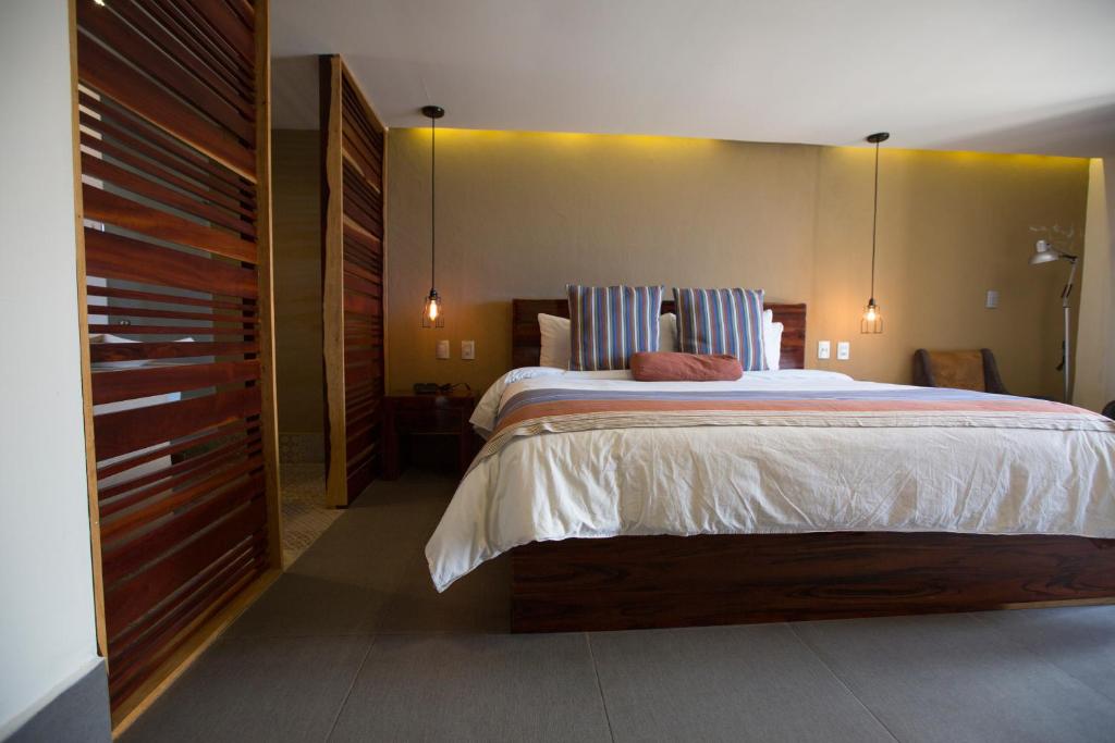 Postel nebo postele na pokoji v ubytování Hotel Helverica