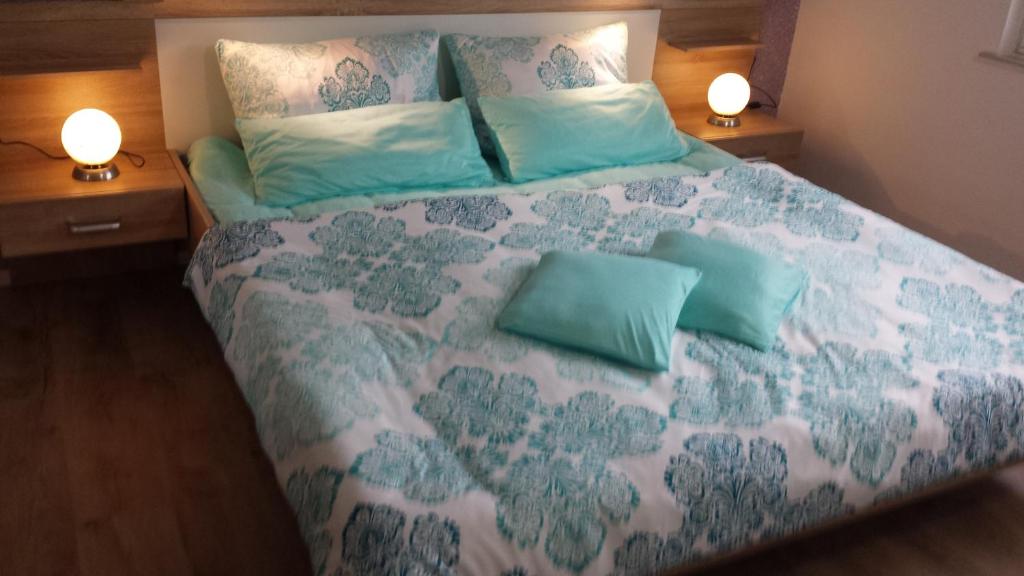 a bedroom with a large bed with two night stands at Ferienwohnung Loreley in Lierschied