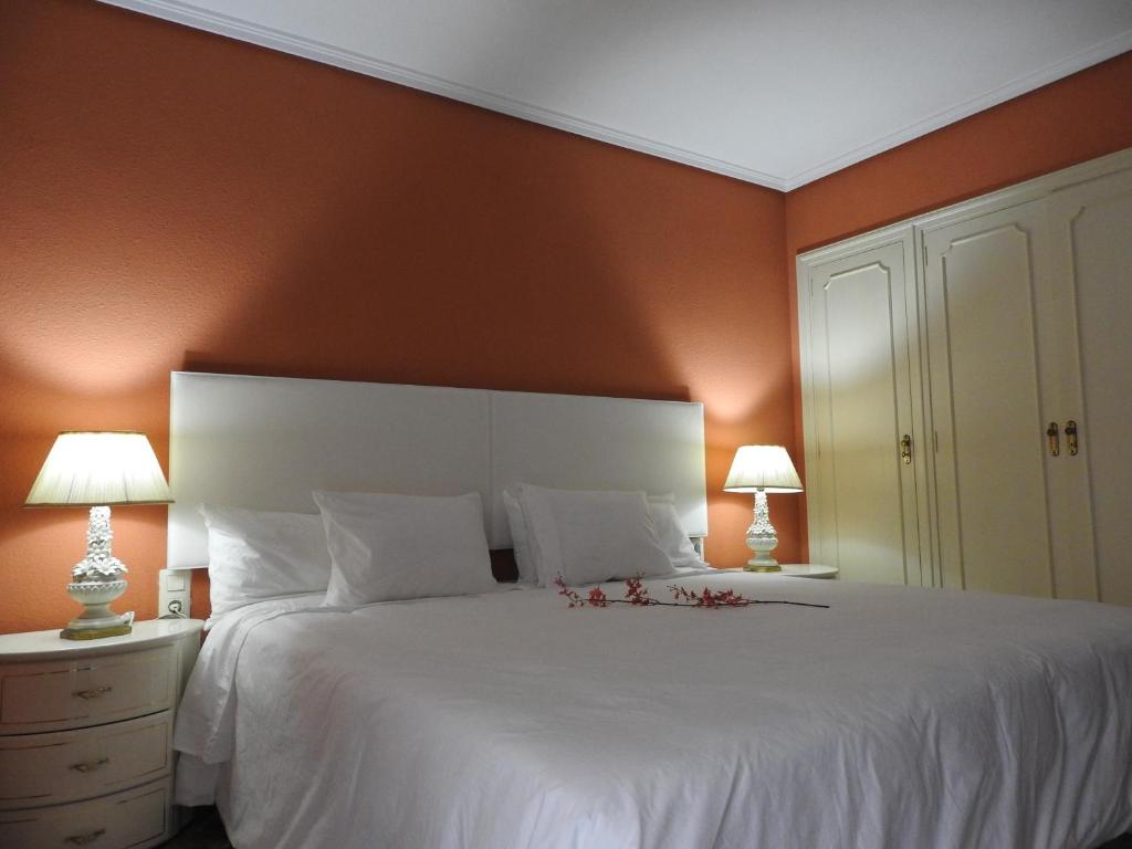 ハベアにあるApartamento Puerto Jáveaのベッドルーム1室(オレンジ色の壁の大きな白いベッド1台付)