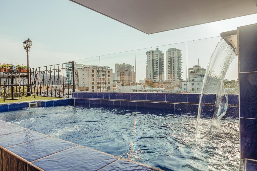 聖瑪爾塔的住宿－Hotel Boutique ADAZ，一座建筑物屋顶上带喷泉的游泳池
