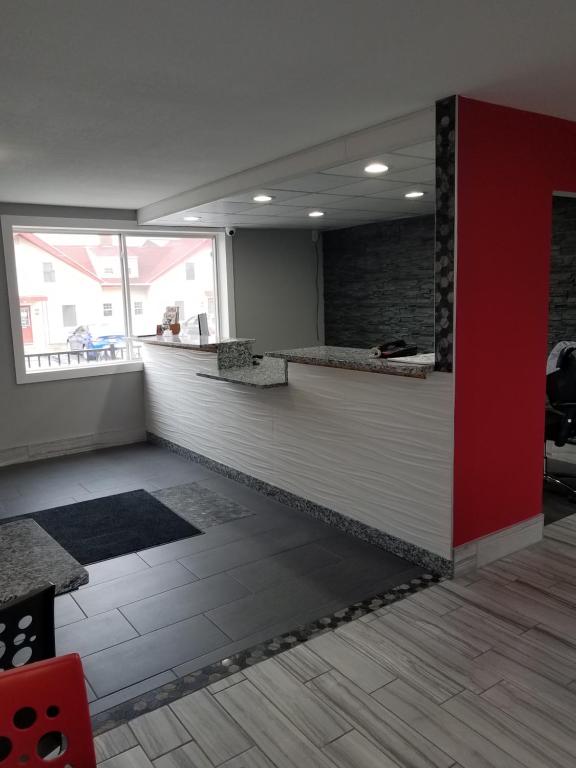 an empty office with a red and white counter at Red Carpet Inn Rochester in Rochester