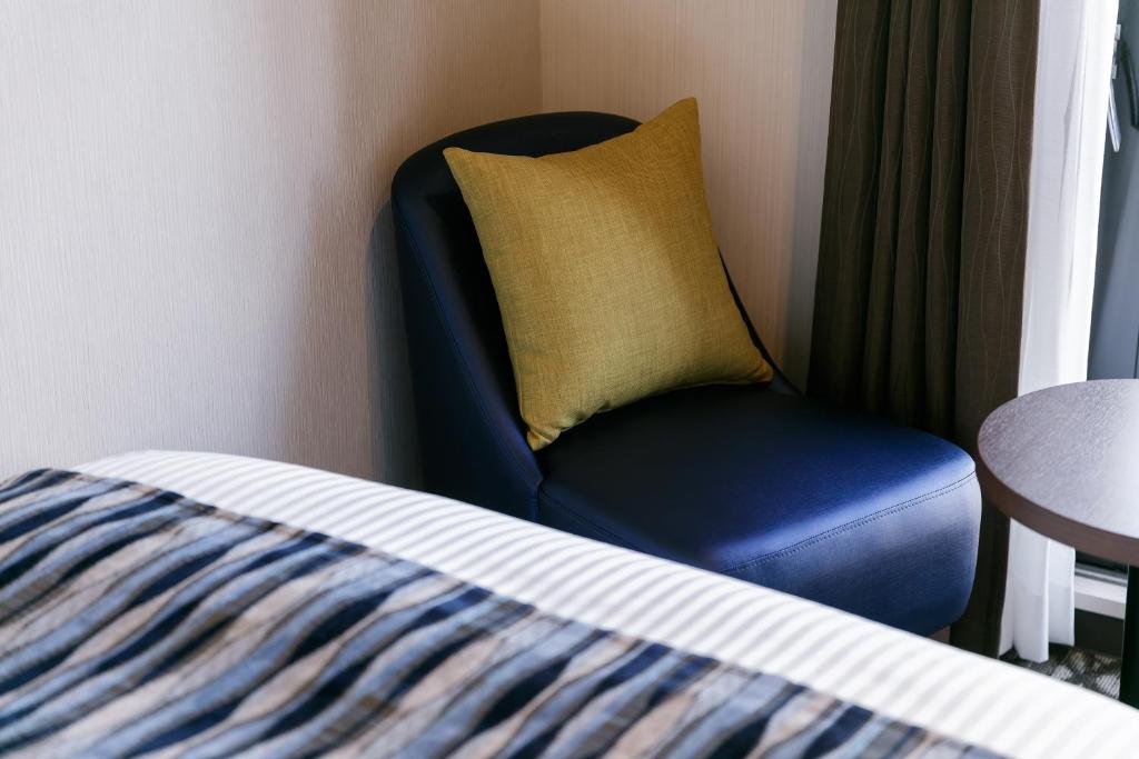 Postel nebo postele na pokoji v ubytování Hotel Mystays Kagoshima Tenmonkan Annex