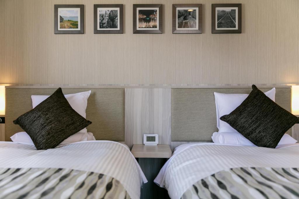 Postel nebo postele na pokoji v ubytování Hotel Mystays Kagoshima Tenmonkan Annex
