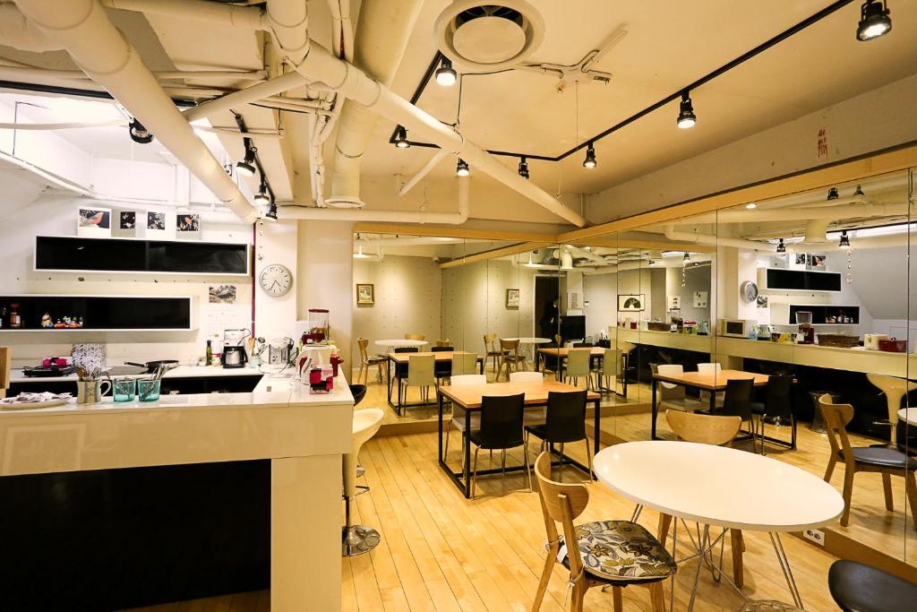 a restaurant with tables and chairs in a room at Mama Guesthouse Myeongdong in Seoul