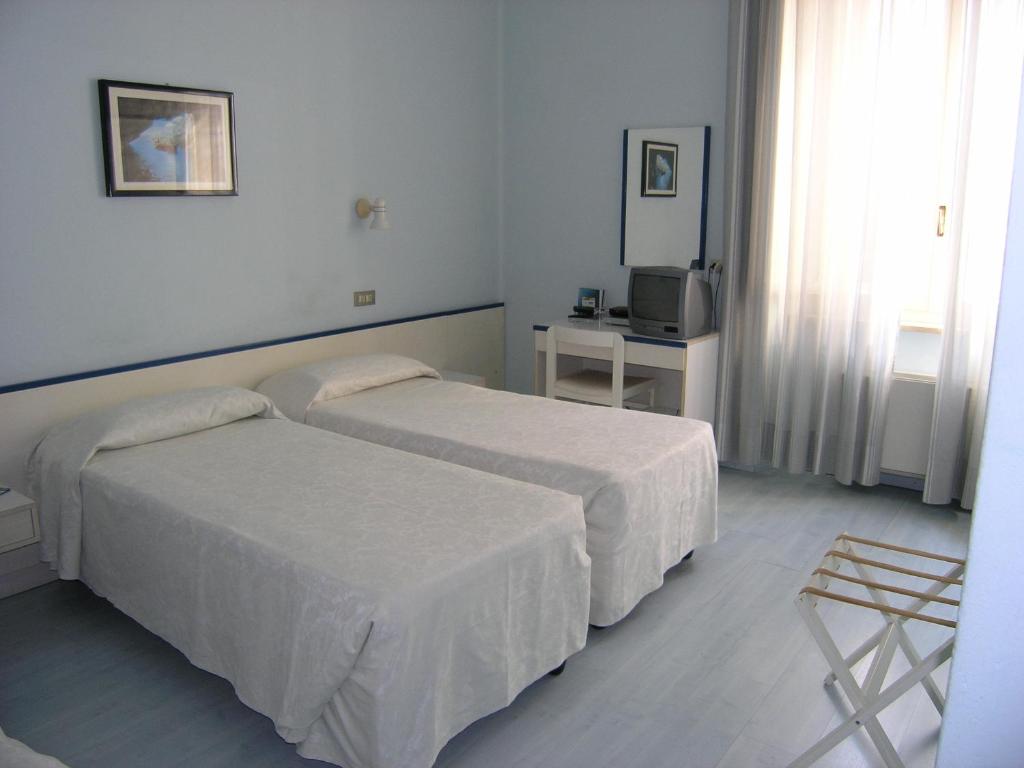 Postel nebo postele na pokoji v ubytování Elba Hotel