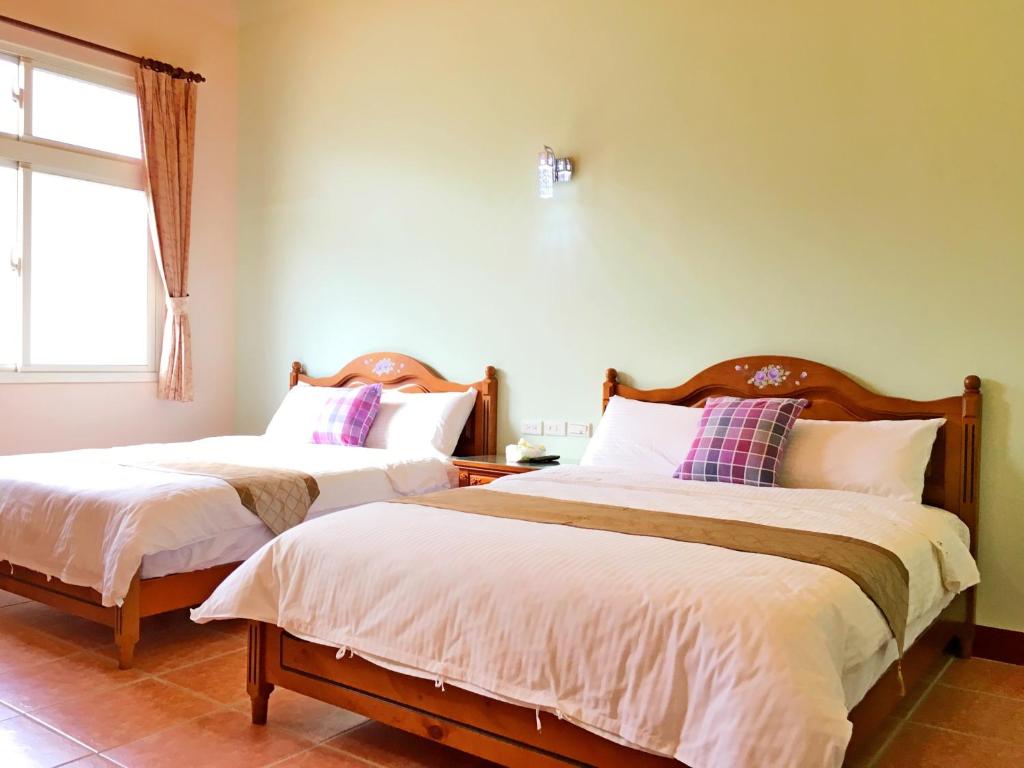 Postel nebo postele na pokoji v ubytování Jiang Shui Village B&B