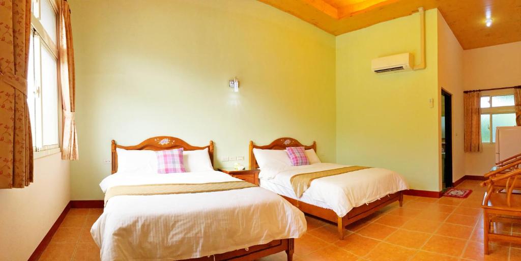 Postel nebo postele na pokoji v ubytování Jiang Shui Village B&B