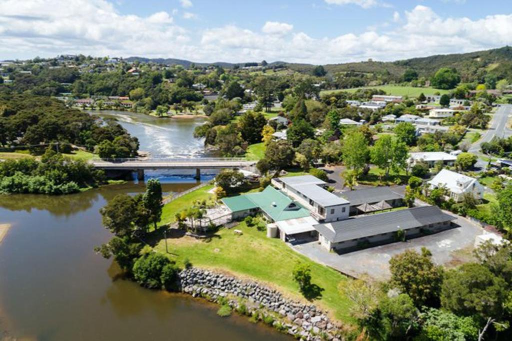 an aerial view of a house next to a river at Riverside Lodge Paihia in Paihia