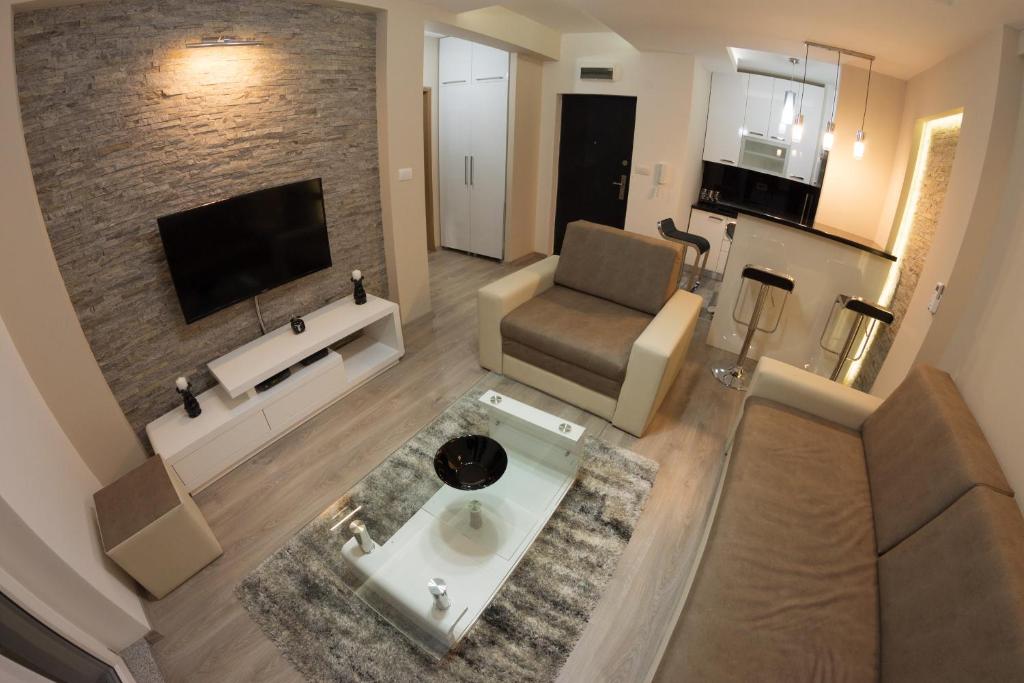 an overhead view of a living room with a couch and a television at Diva Lux Apartman in Belgrade