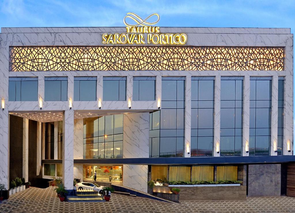 a building with a sign on the front of it at Taurus Sarovar Portico in New Delhi