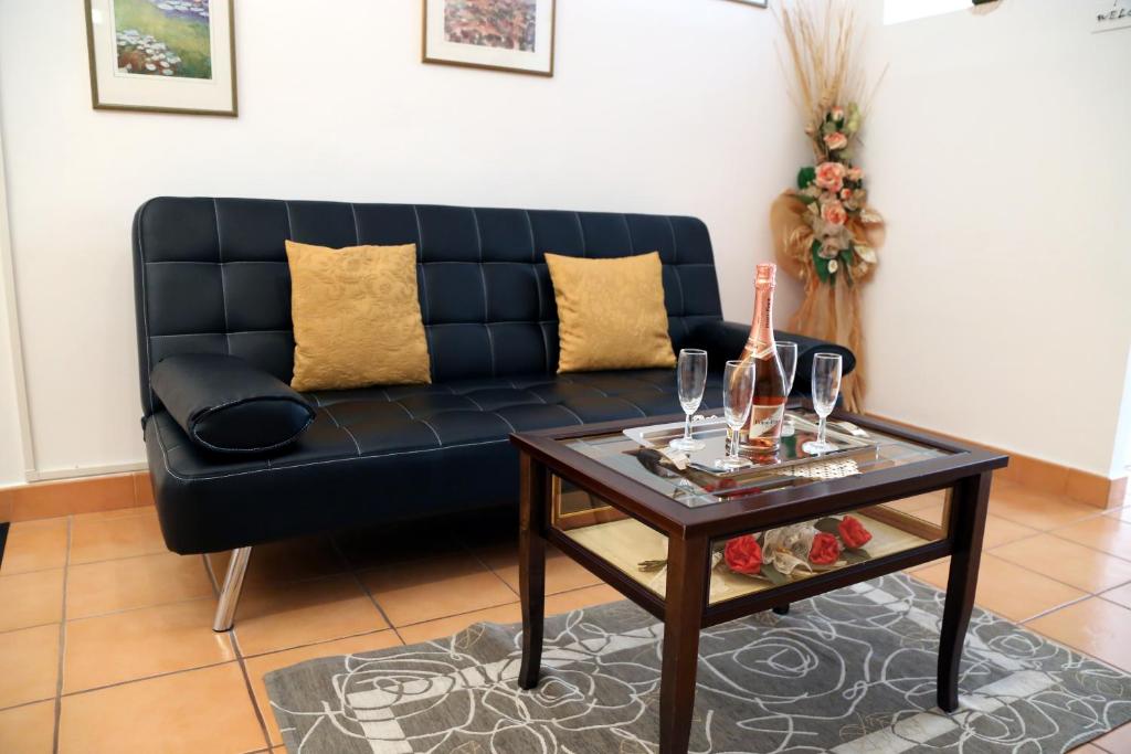 a black couch sitting in a living room with a table at La Casa Dei Pargoli in Matera