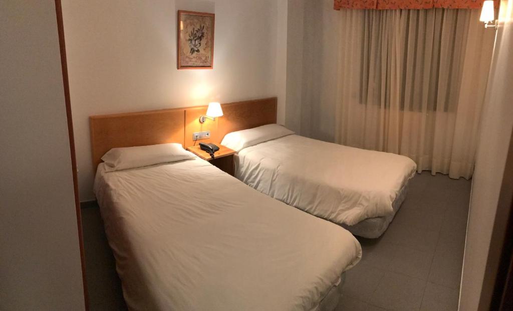 Postel nebo postele na pokoji v ubytování Apartamentos Turísticos Roc Del Castell