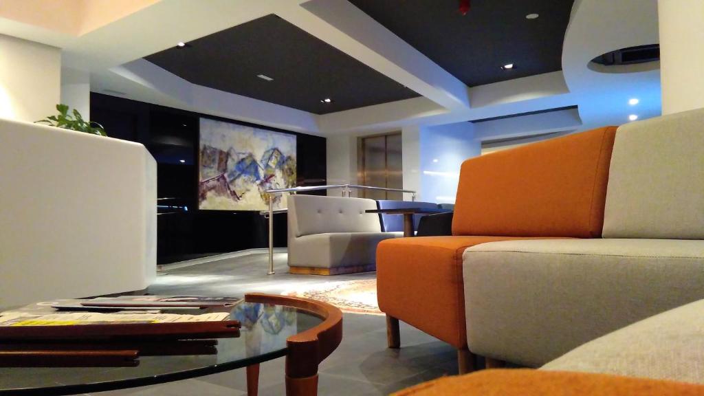 a living room with a couch and a table at Hotel Parma in San Sebastián