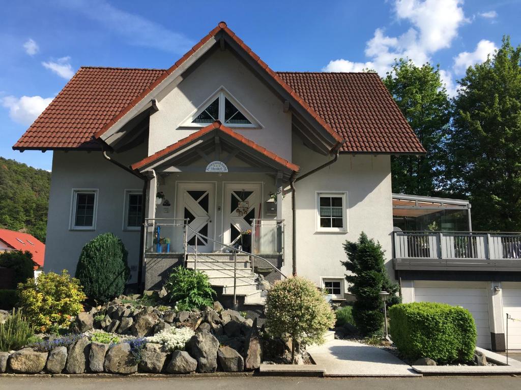 a house with rocks in front of it at Ferienwohnung Hankel in Hemfurth-Edersee