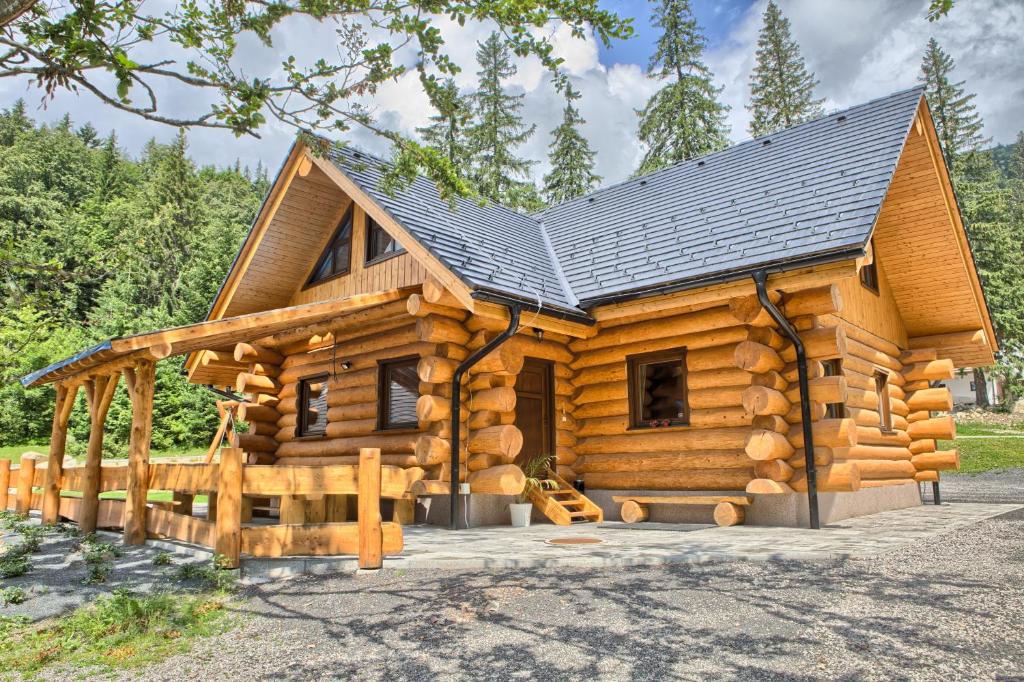 a log cabin with a black roof at Zruby Pod Chopkom in Tale