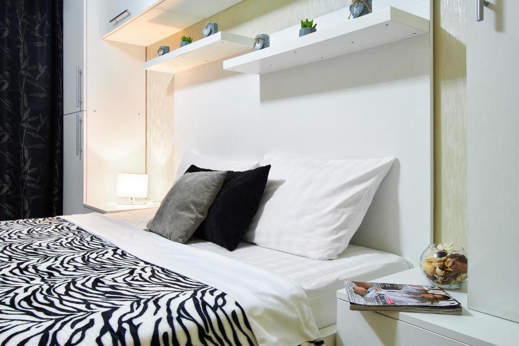 a bedroom with a zebra print bed with a mirror at PaulMarie Apartments on Kozhara in Gomel