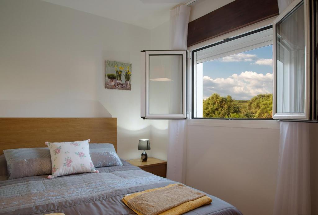 a bedroom with a bed and a large window at Casa Adofreire in Melgaço