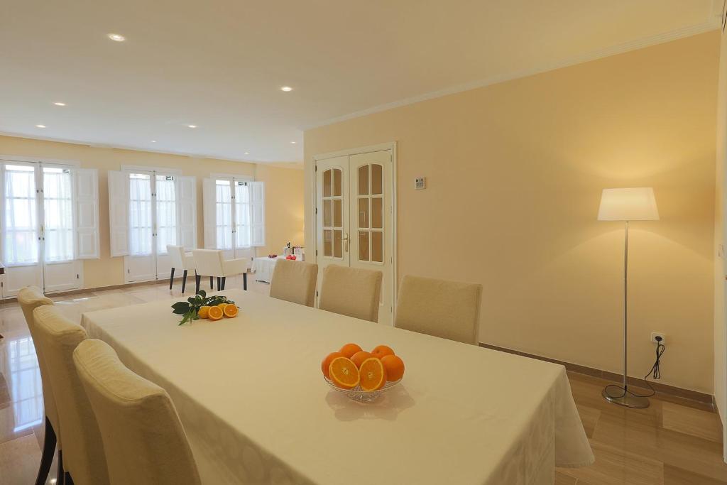 a dining room with a table with oranges on it at Epicenter in Seville