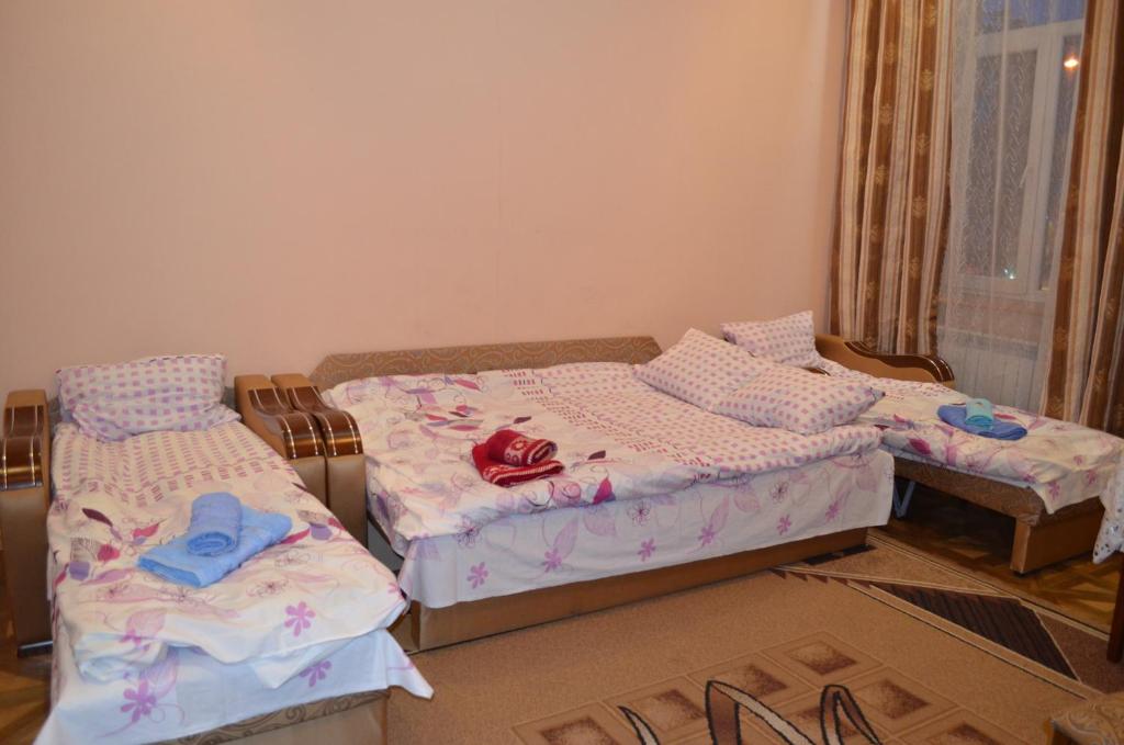 two beds in a room with clothes on them at Пляц Пруса/Plac Prus in Lviv