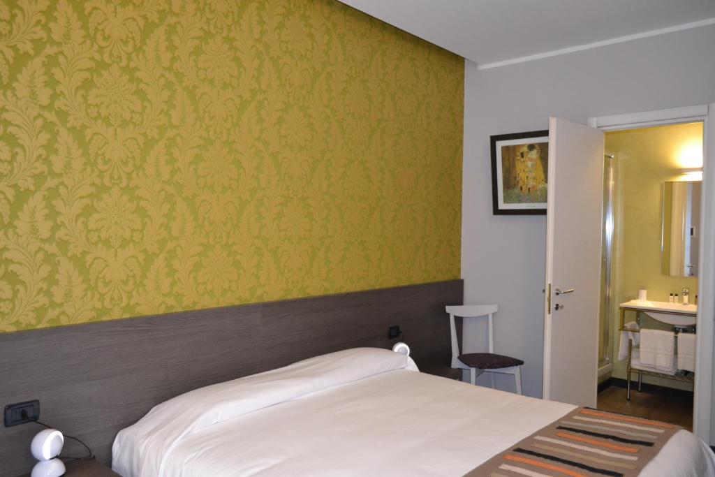 Postel nebo postele na pokoji v ubytování MA Hotel