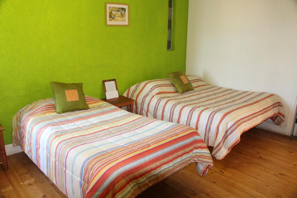 Postel nebo postele na pokoji v ubytování Cabañas, Habitaciones y Restaurant Montemar
