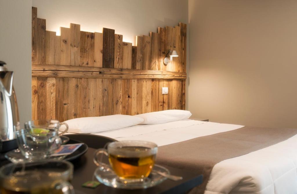 a bedroom with a bed and a table with drinks at Monte Emilius in Aosta