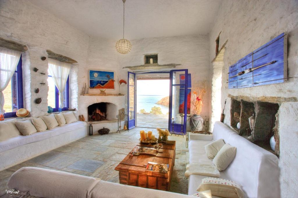 a living room with a couch and a fireplace at Amelia Beachfront Villa in Korissia