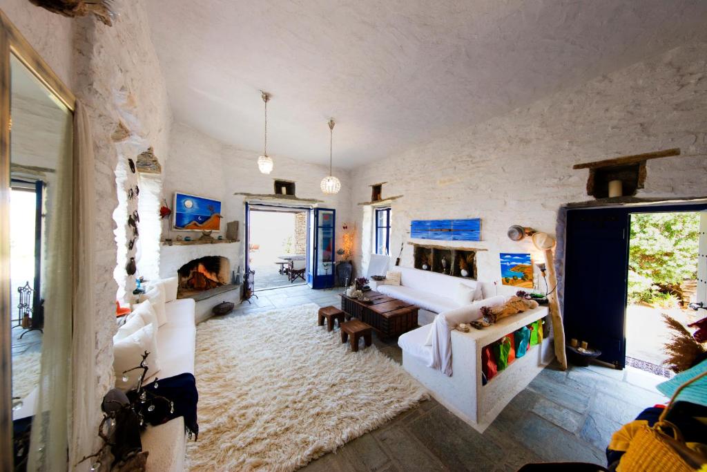a large living room with a couch and a fireplace at Amelia Beachfront Villa in Korissia
