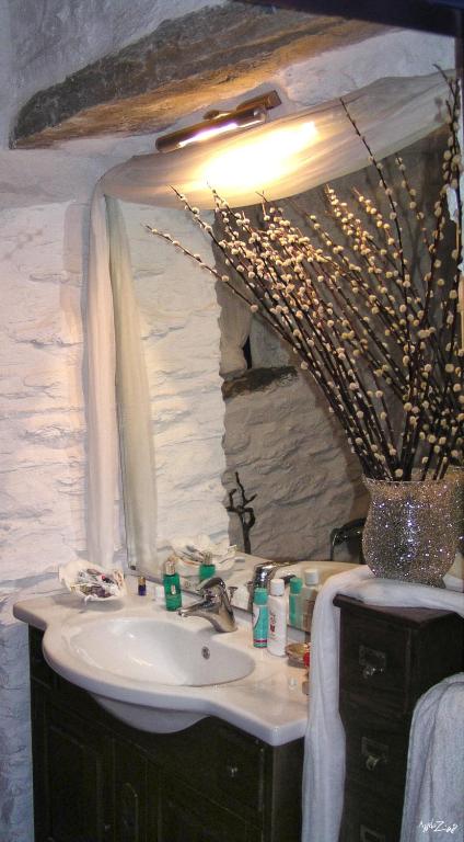 a bathroom with a sink and a mirror at Amelia Beachfront Villa in Korissia