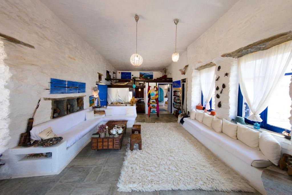 a living room with a large couch and windows at Amelia Beachfront Villa in Korissia