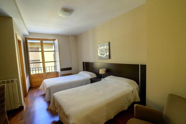 Postel nebo postele na pokoji v ubytování Hostal El Palacio