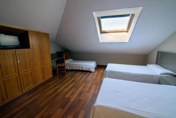 Postel nebo postele na pokoji v ubytování Hostal El Palacio