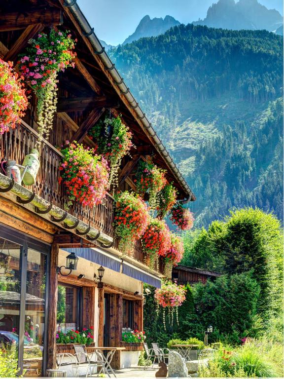a building with flowers on the side of it at Auberge du Manoir in Chamonix