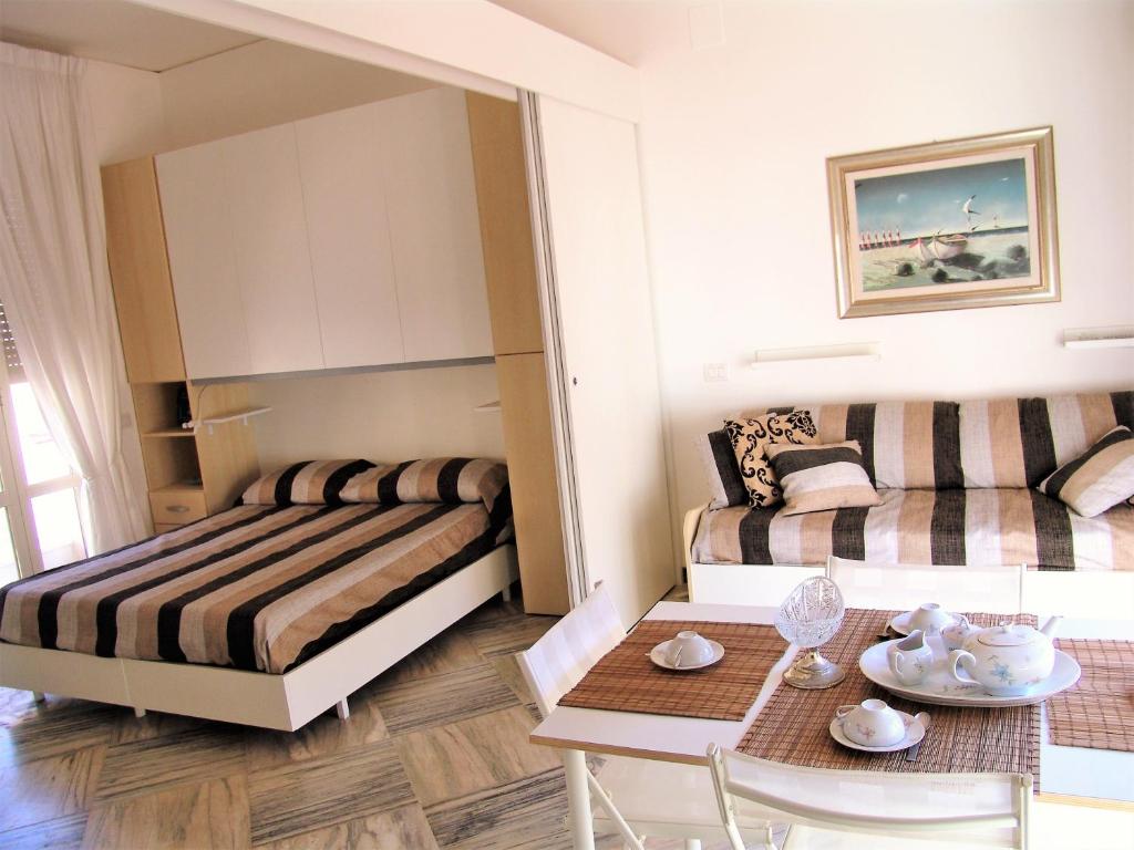 Habitación pequeña con 2 camas y mesa. en Casa Privata FOR YOU, en Minori