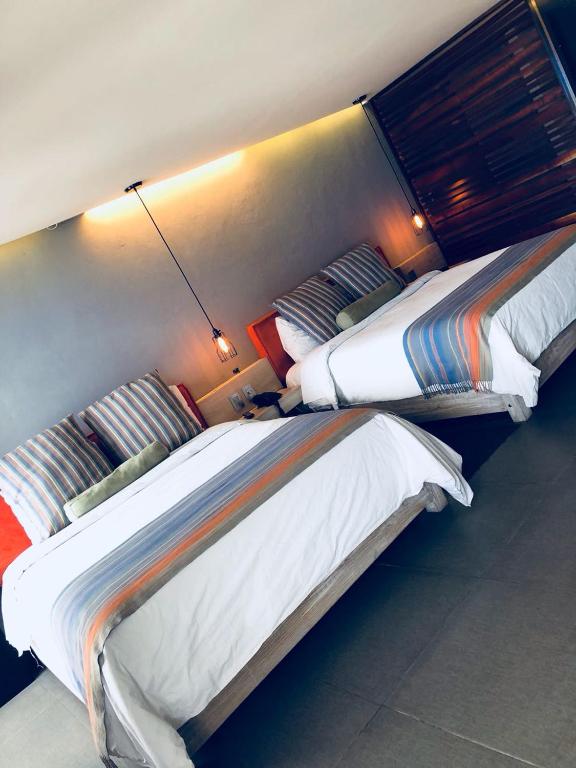 Postel nebo postele na pokoji v ubytování Hotel Helverica