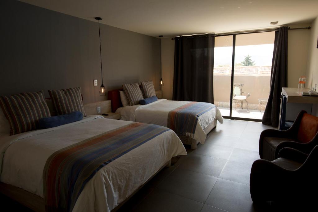 Postel nebo postele na pokoji v ubytování Hotel Helverica