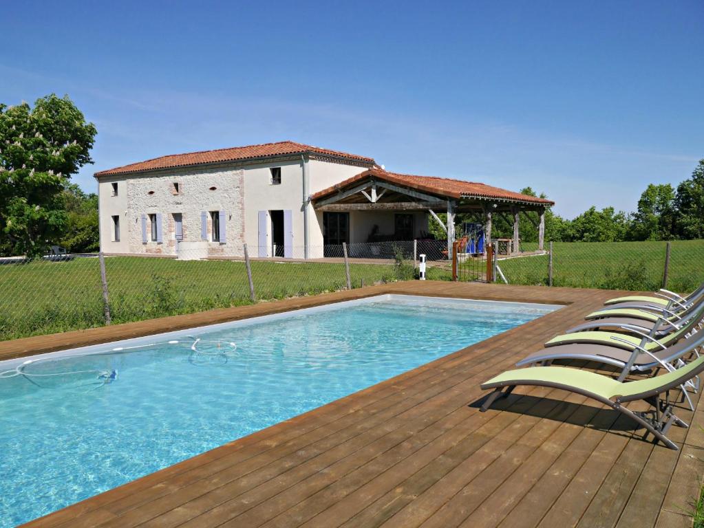 una piscina con sillas y una casa en Gite Pech De Durand Villeneuve Sur Lot, en Villeneuve-sur-Lot