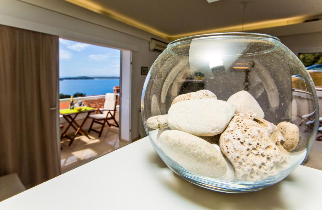 a glass bowl filled with rocks on top of a table at Apartments Tatjana Dominis in Hvar