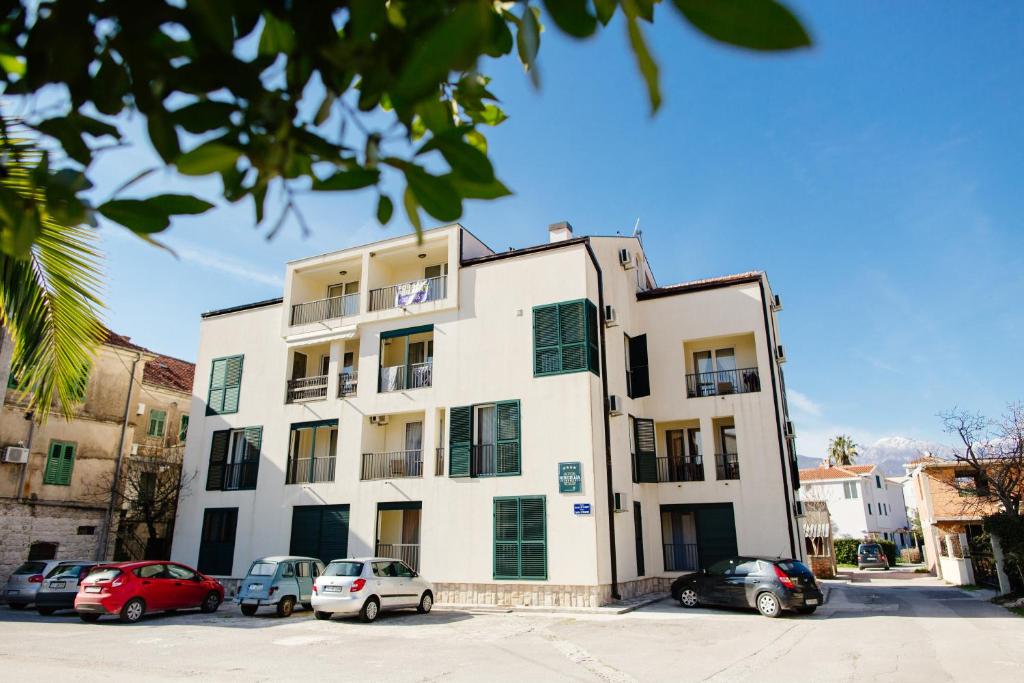 a building with cars parked in front of it at Apartments Nirgilija in Tivat