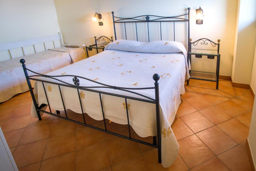 a bedroom with two beds and a tiled floor at Il Glicine in Cetara