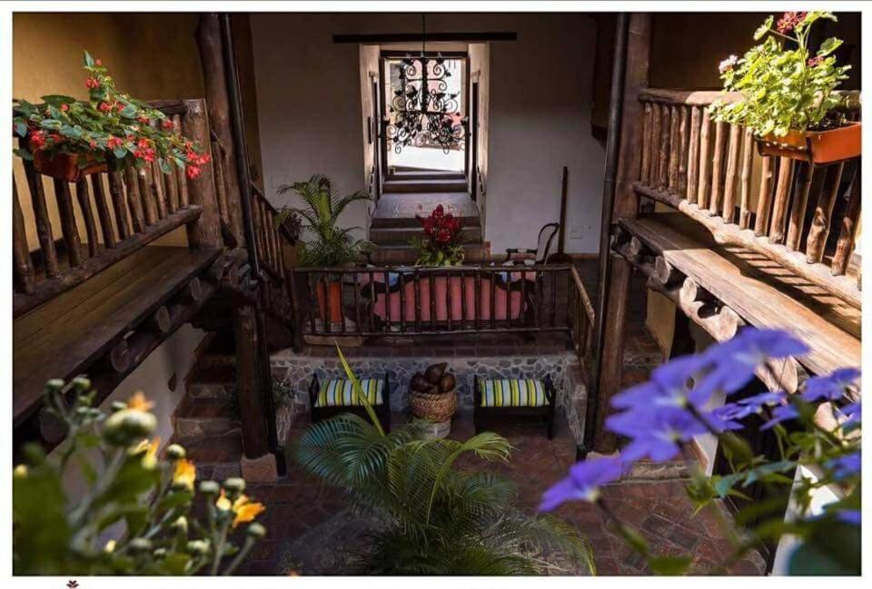 a view of a room with plants and a window at Hotel Boutique Quinta Tibigaro in San Vicente de Chucurí