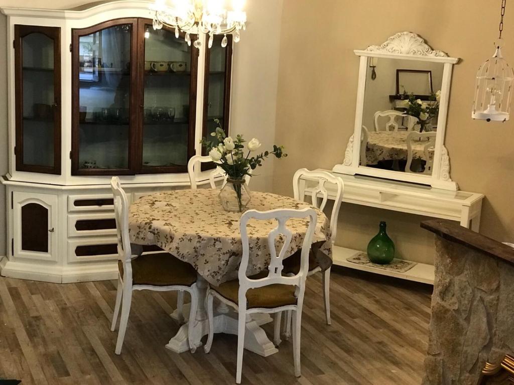a dining room with a table and chairs and a mirror at le Piagge in Viterbo