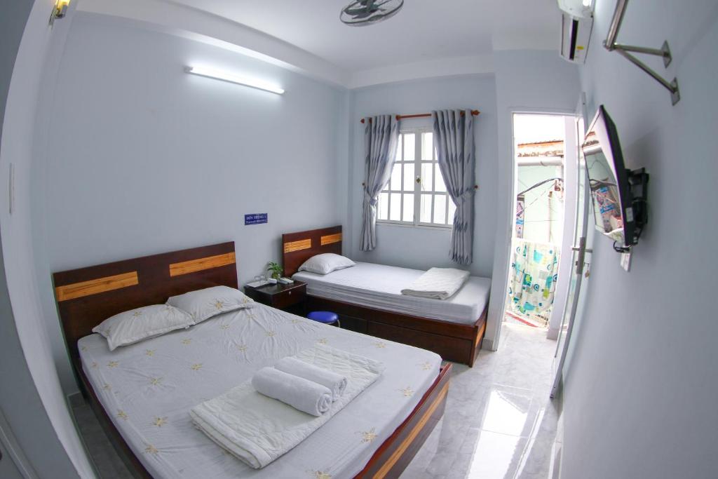 Ένα ή περισσότερα κρεβάτια σε δωμάτιο στο SƠN THỊNH Guesthouse