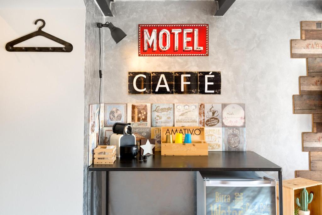 a sign for a motel cafe on a wall at Casabera in Trani